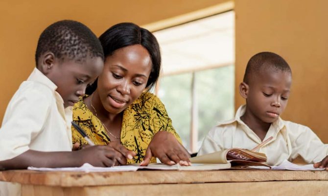 teacher-helping-kids-class